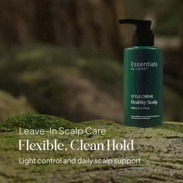 Essentials by LOMA Healthy Scalp Style Crème 6.7 oz bottle displayed on moss with leave-in scalp care and flexible clean hold messaging