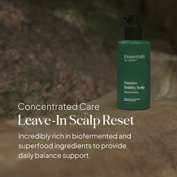 Essentials by LOMA Healthy Scalp Treatment bottle displayed outdoors with concentrated leave-in scalp care and daily balance support messaging