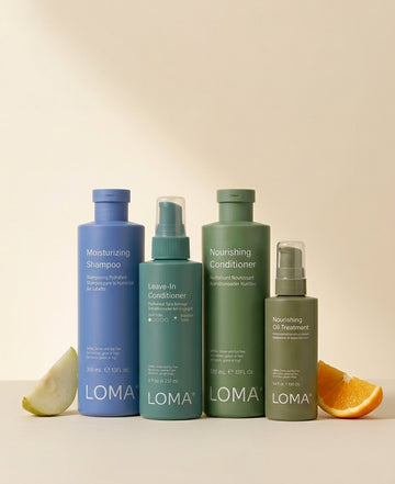 LOMA Moisturizing Shampoo, Nourishing Conditioner, Leave-In Conditioner and Nourishing Oil Treatment on a beige background