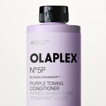 Close-up of an OLAPLEX Nº.5P Blonde Enhancer Purple Toning Conditioner bottle showing the purple-toning formula label