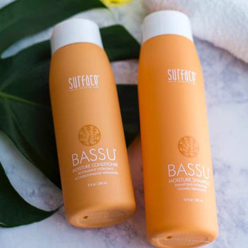 Surface BASSU Moisture Conditioner and Moisture Shampoo bottles photographed together.