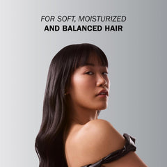Model with smooth dark hair demonstrating soft, moisturized and balanced hair