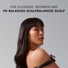 Model with long, straight, glossy dark hair demonstrating a cleansed and balanced scalp result.