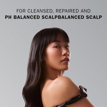 Model with long, straight, glossy dark hair demonstrating a cleansed and balanced scalp result.