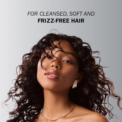 Model with soft defined dark curls demonstrating a cleansed and frizz-free hair result