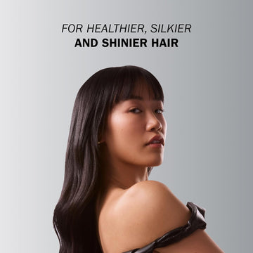 Model with long, sleek dark hair and straight bangs demonstrating a healthier, silkier and shinier hair result