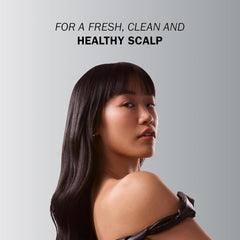 Model with long, straight, glossy dark hair demonstrating the fresh, clean and healthy scalp result of TRUSS Therapy Shampoo.