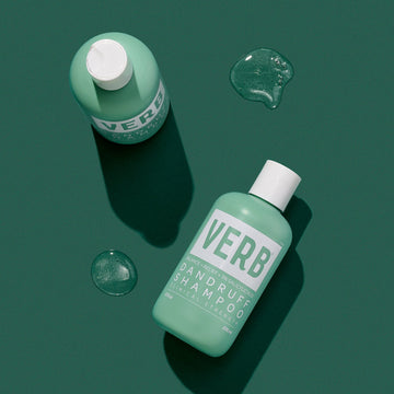 Verb Dandruff Shampoo 8 oz bottle and green shampoo texture on a dark green background