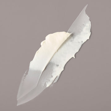 White Verb Sculpting Clay styling product texture smeared on a gray background